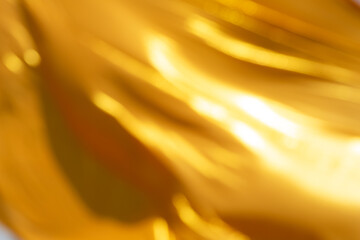 Light luxury golden blurred gradient background has a little abstract light,shadow flash light background, blurred yellow cloth for graphic desig, presentation, blackdrop, wallpaper