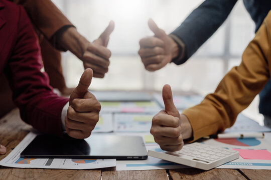 Business team giving thumbs up praise during successful businesswoman showing laptop computer for presentation at financial business group board meeting Close-up pictures - Powered by Adobe