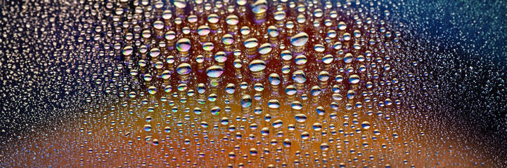 Water drops banner. Many drops abstract background. Colored drop texture. Rainbow gradient. Heavily...