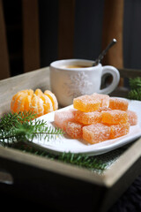 Christmas citrus dessert, orange jelly sweets and cup of coffee, New Year's decoration - 668700693