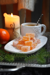 Christmas citrus dessert, orange jelly sweets and cup of coffee, New Year's decoration - 668700808