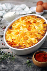 French cuisine. Vegetable pumpkin clafoutis in ceramic bakeware, smoked paprika dressing, eggs and cream - 668700892