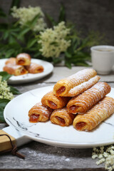 Fripons, French pastries. Jam filling sweet puff pastry rolls and spring elderberry flowers - 668701271