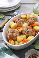 Braised meat paupiettes with potatoes and bell pepper in ceramic bakeware - 668701857