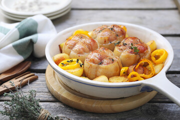 Braised meat paupiettes with potatoes and bell pepper in ceramic bakeware - 668702027