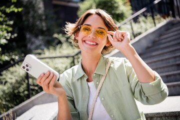 Photo of cute cheerful girl spending free time outdoors autumn weekend pastime last summer days...