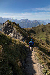 Hiker in the mountains, Stoos, Schwyz, Switzerland