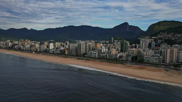 Drone Footage of Ipanema Beach in Rio De Janeiro in Brazil. The video is a 180 rotation and going higher to see the ipanema beach from the begining to end up to the favela Vidigal.