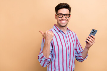 Portrait of successful ceo manager holding phone pointing finger empty space download google...