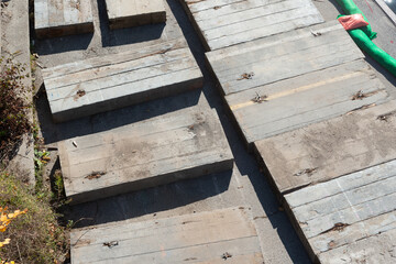 large wooden platforms on the ground (photo taken from the bridge)