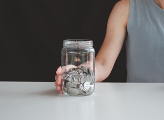 saving money and investment concept. Money coin stack growing graph and coins in jug glass. Balance savings Interest and investment Concept. Business planning and financial management.