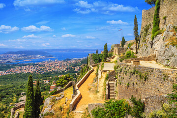 Summer landscape - view of the Klis Fortress and the city of Split, on the Adriatic coast of Croatia - obrazy, fototapety, plakaty