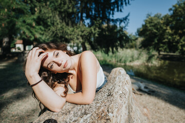 Caucasian best friends enjoy nature in a city park. They have a carefree, cheerful time, talking and laughing. It's their day off, having fun and relaxing in the green environment.