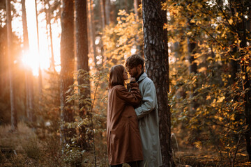 beautiful couple of young people in the forest love each other, valentine's day