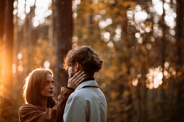 beautiful couple of young people in the forest love each other, valentine's day