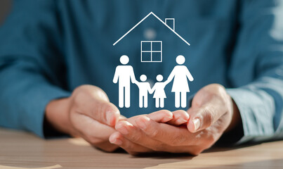 Family insurance and safety concept,  Man hand holding family icon with house for protecting and care.