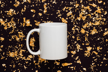 White mockup mug on black  background with golden glitter, top view. Mockup mug for gift, logo, branding and design. Christmas, New Year and holidays concept