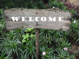 Rectangular wooden sign with white letters. 