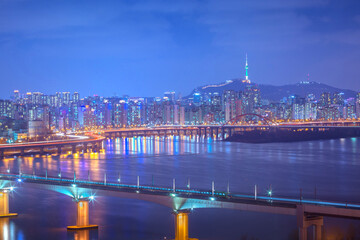 Pictures of Seoul at night and Metro bridge over the Han River and Namsan Mountain in the background, South Korea.