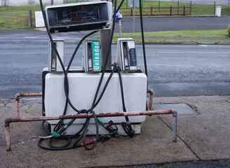 Old abandoned petrol and diesel pump at the roadside