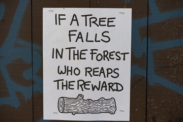 a paper bill with a philosophical question in the park