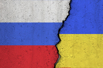 Russia and Ukraine flags cracked on a concrete background
