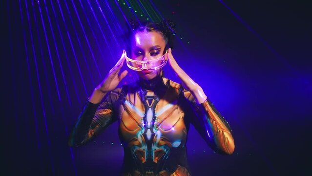 Portrait Fantasy cyborg woman robot costume glowing glasses metal body cyberpunk style hair. Sexy alien girl in virtual reality game lady warrior future vr laser light smoke. Fashion model posing. 4k