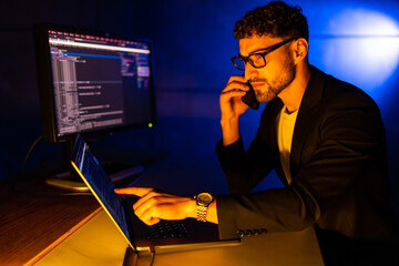 Portrait of busy developer speak telephone coworking start-up project midnight house inside