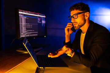 Portrait of busy developer speak telephone coworking start-up project midnight house inside