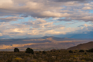 Cloudy picturesque Sunrise in Owens Valley. Golden lighting and plants during fall in the Buttermilks at the foothills of the Sierra Nevada Mountains.