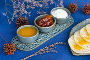 Homemade Moroccan traditional pancakes Baghrir with creamy honey sauce