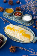 Homemade Moroccan traditional pancakes Baghrir with creamy honey sauce