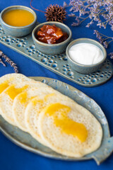 Homemade Moroccan traditional pancakes Baghrir with creamy honey sauce