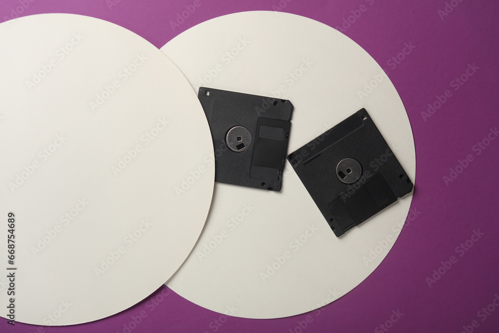 Poster retro 80s floppy disks on purple background with white circles. top view