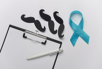 Blue ribbon symbolizing support of men, mustache and clipboard on dark background. Blue november...