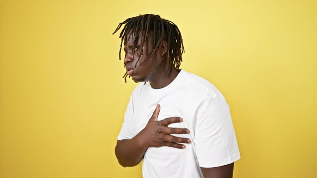 African american man coughing over isolated yellow background