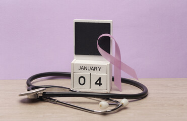 Purple awareness ribbon and calendar with date january 04 and stethoscope