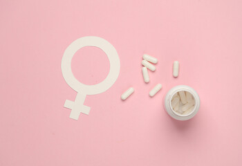 Female gender symbol with pills on pink background - obrazy, fototapety, plakaty
