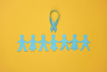 Paper-cut chain of people and Prostate Cancer Awareness Blue Ribbon on yellow background. Unity, support, together we are stronger