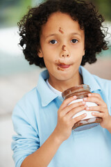 Cute, portrait and child with chocolate spread at a home with delicious, sweet snack or treat....