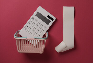 Blank Cash Receipt Sales Check and Shopping Basket with Calculator on pink background