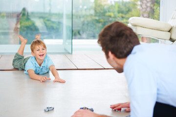 Father, child and playing on floor with toys, family home and happy with support of businessman. Man, boy or together to relax with smile, fantasy game and learning trust papa for love of cars - obrazy, fototapety, plakaty