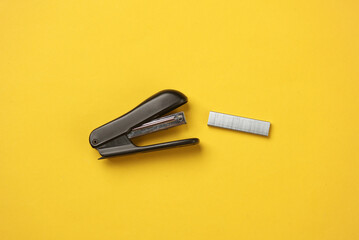 Stapler with bullets starting on yellow background