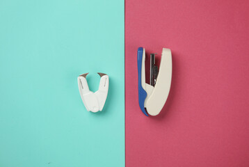 Anti-stapler with a stapler on a blue pink background