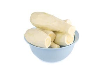 Peeled zucchini in a blue bowl on a white background.