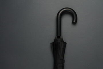 Black umbrella hook on a dark background