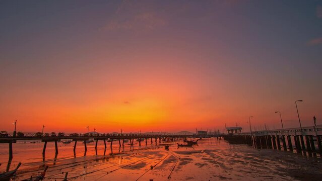 time lapse colorful red sky above Chalong pier in sunrise..Nature video High quality footage Scene of Gradient color romantic sky..scene of romantic sky in sunrise above Chalong pier.