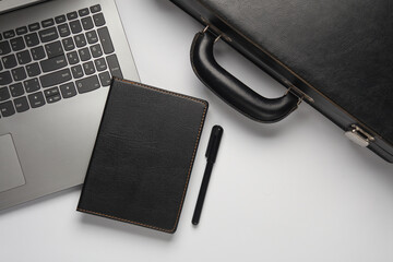 Laptop, Leather suitcase with notebook on white background. Business concept. Top view