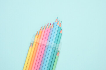 Set of colored pencils on a blue background