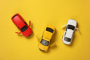 Car and taxi models on yellow background. Travel, vocation concept